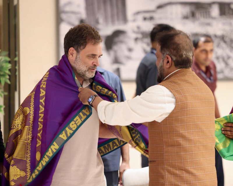 A guest is presented with a shawl at the graduation