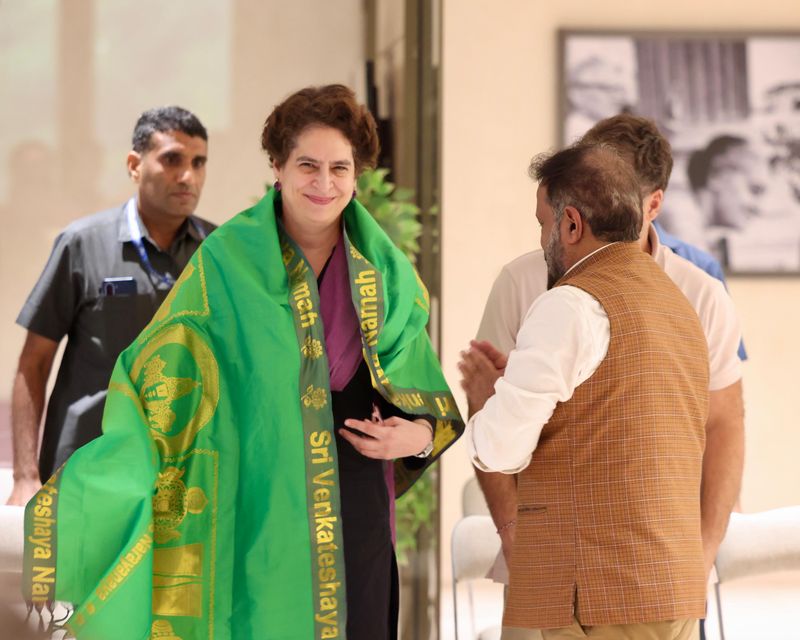 A guest is presented with a shawl at the graduation
